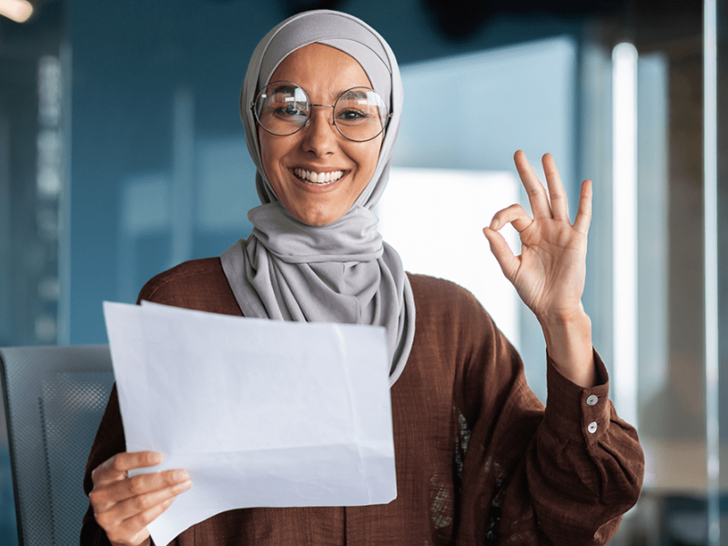 portrait-happy-muslim-woman-hijab-holding-document-letter-sheet-paper-got-good